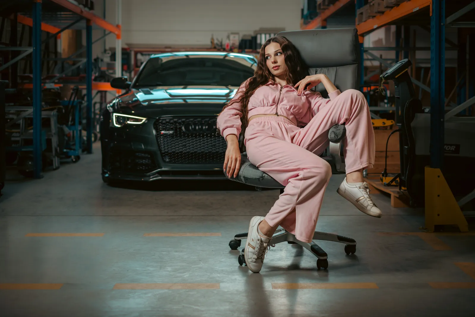 Portrait in pink tracksuit with black Audi RS5